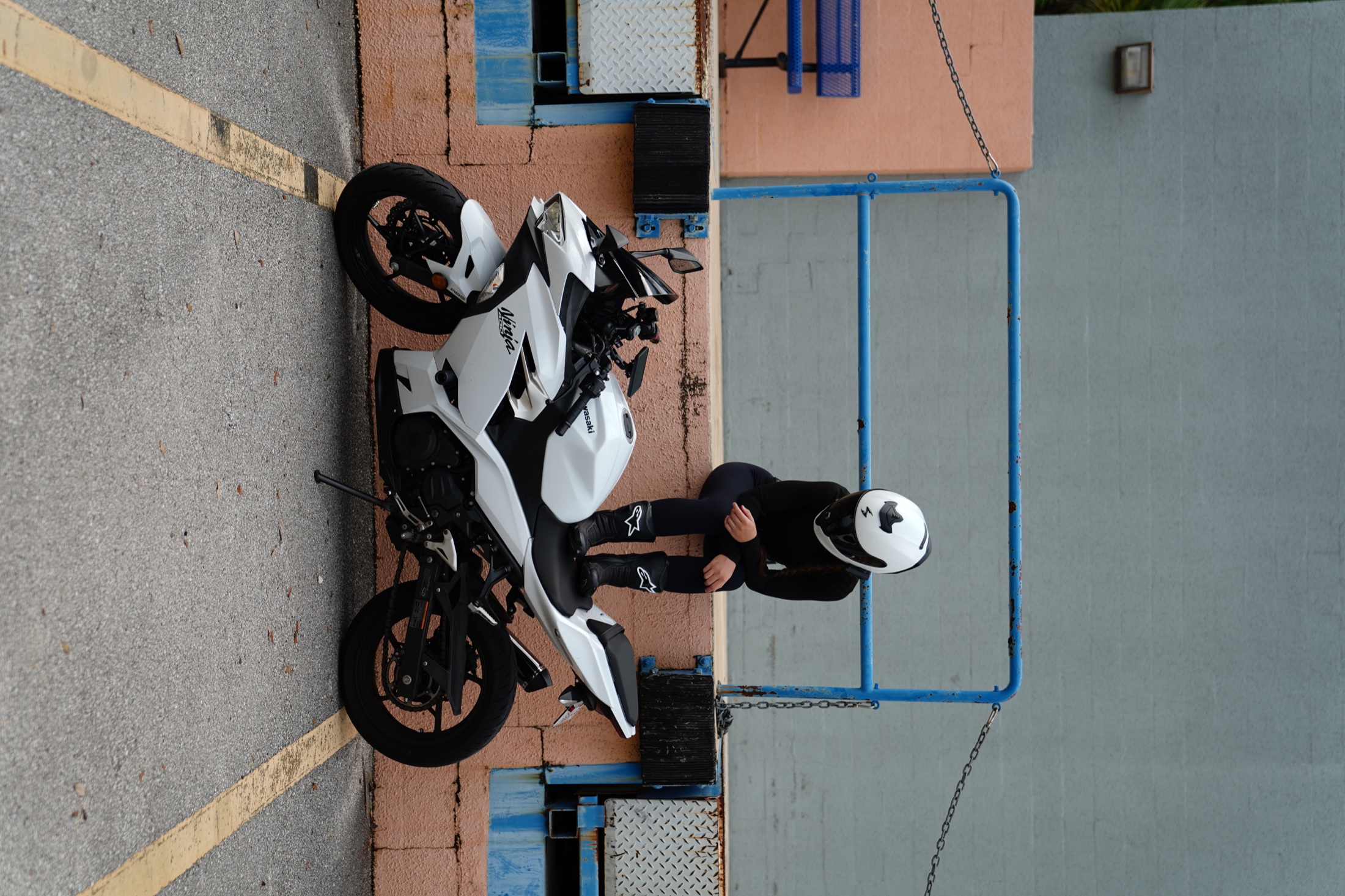 Rider seated above a white Kawasaki Ninja